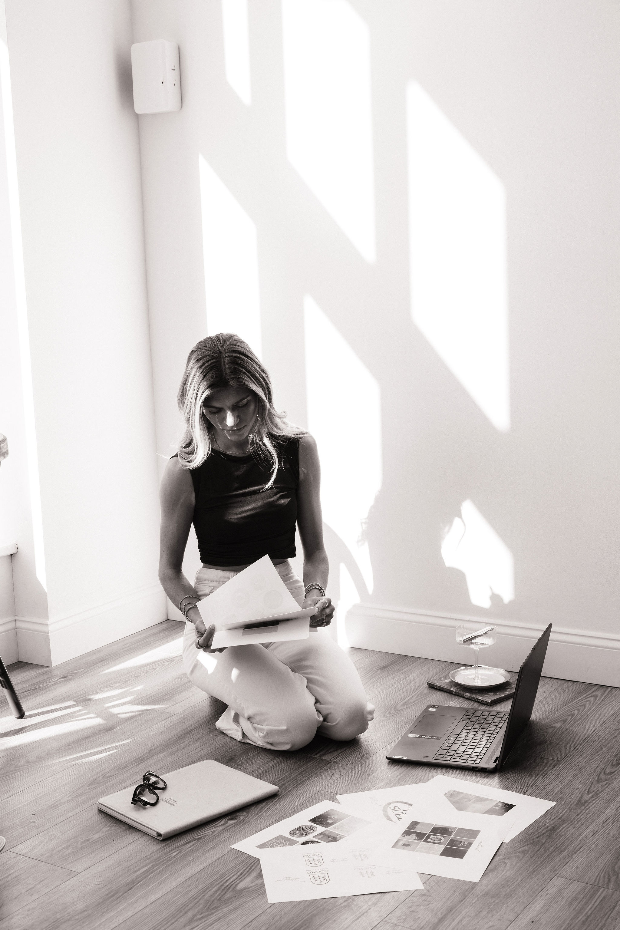 Audrey Noble reviewing brand layouts and mood boards on the studio floor