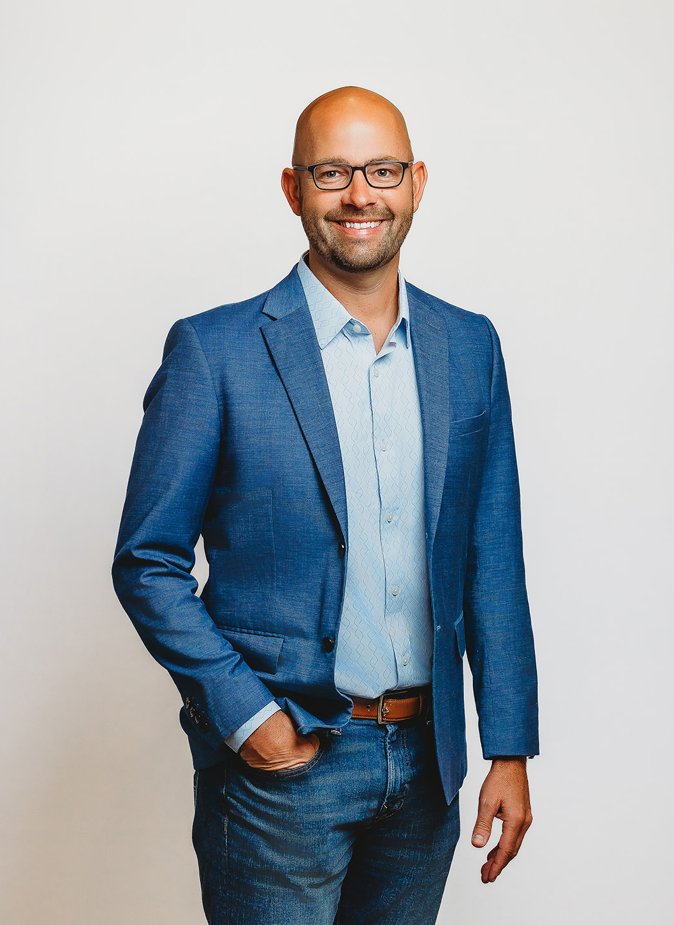 Professional portrait of Brad Zimmerman in a blue blazer