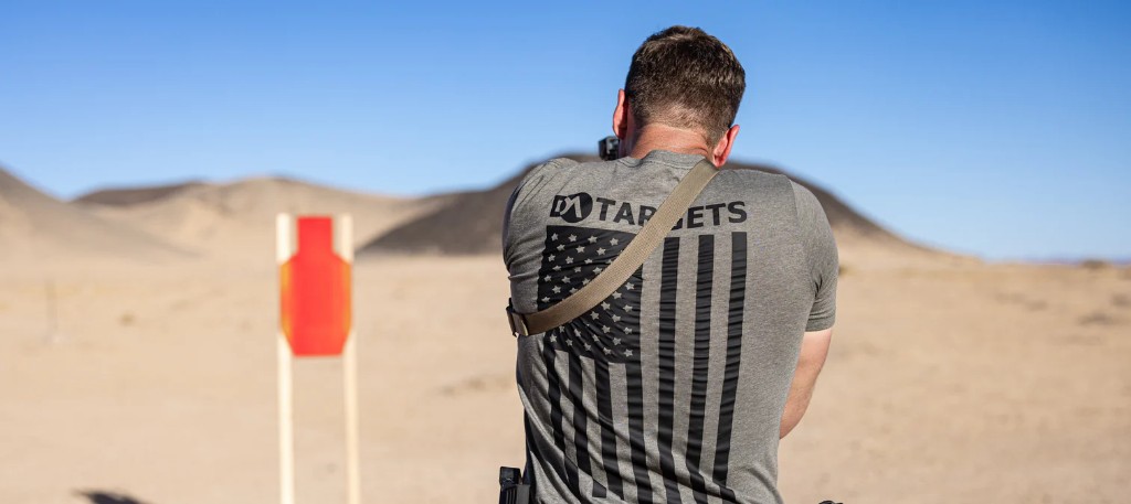 Shooter in a DA Targets tee on a desert range