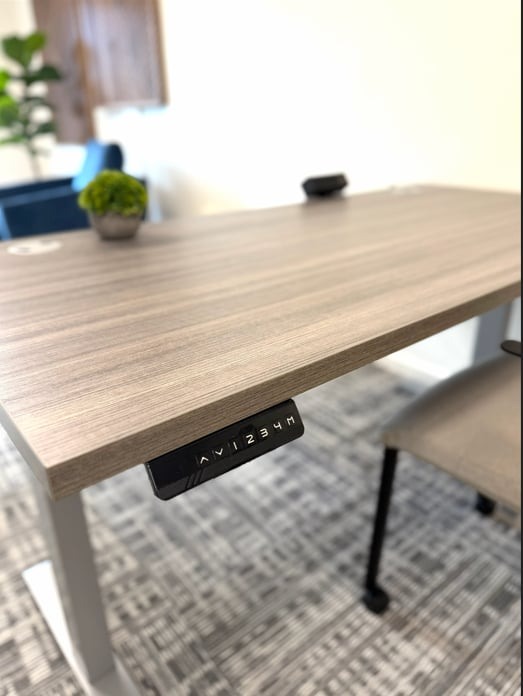 Height-adjustable standing desk control panel in a Hatchworks workspace