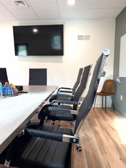 Conference room seating and mounted display at Hatchworks