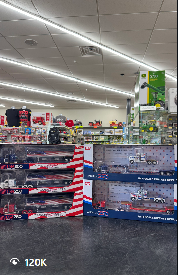 USA 250 die-cast semi trucks stacked on a counter inside Outback Toys