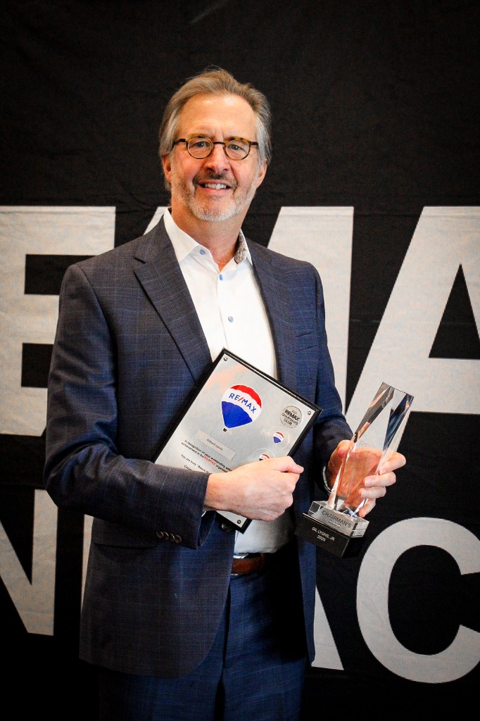 RE/MAX Pinnacle agent Gilbert Lyons with Chairman's Club trophy and 2023 recognition plaque